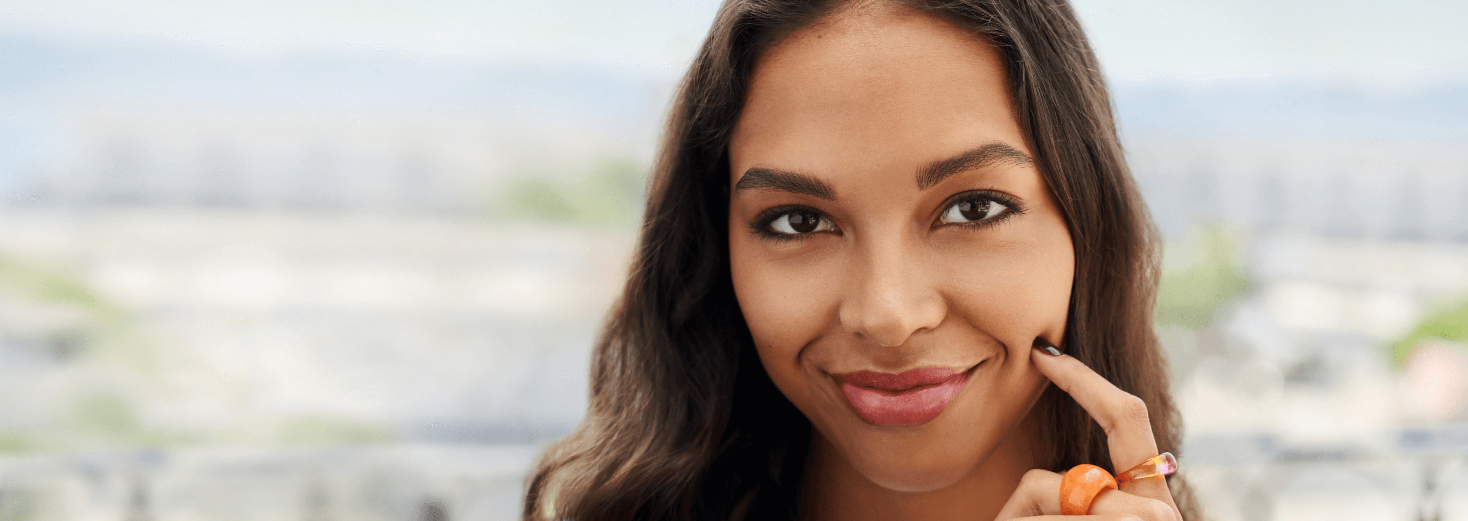 Woman smiling with the city in her background