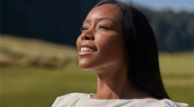 A black women smiling on a beautiful sunny day