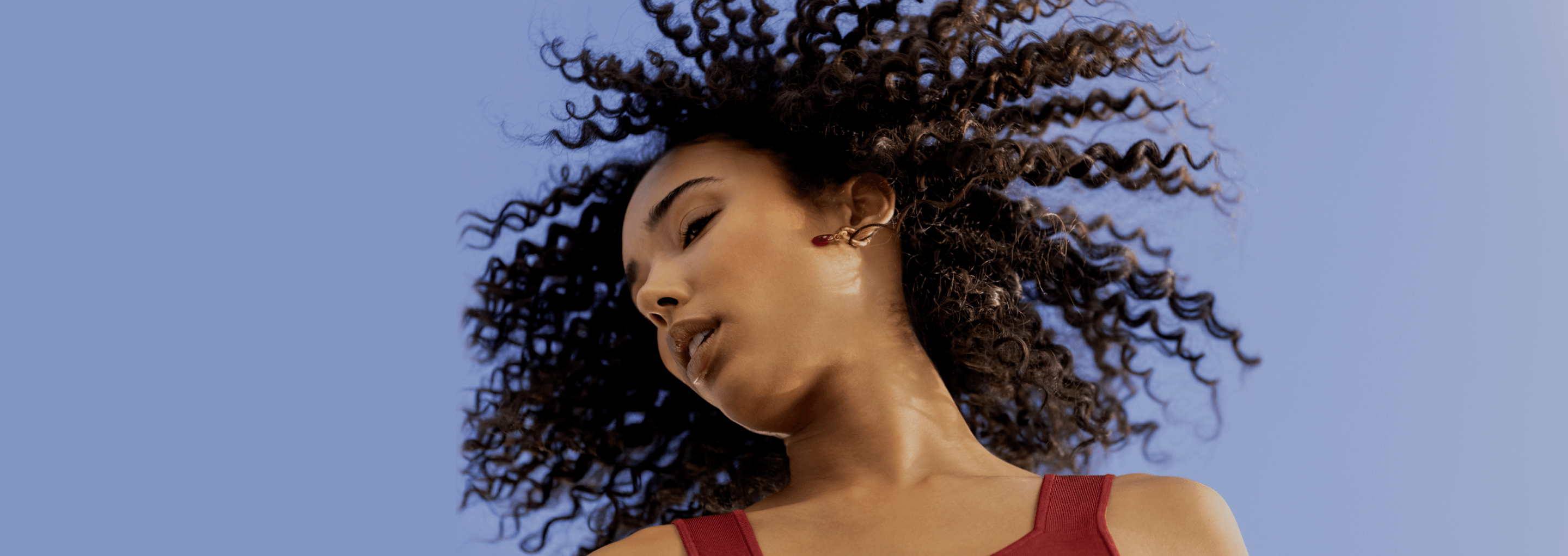 Patient showing her cheek spinning in front of blue sky